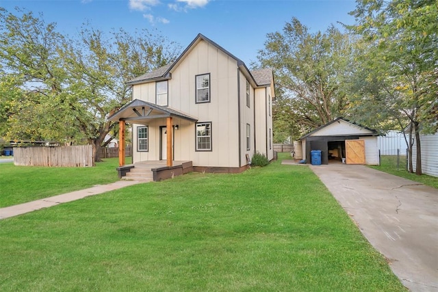 modern farmhouse style home featuring a front yard, a garage, and an outdoor structure