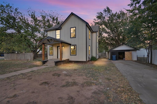 modern farmhouse featuring a garage and an outdoor structure