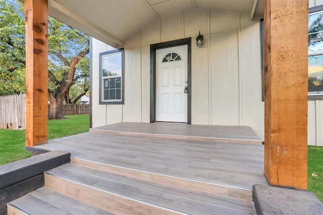 property entrance with a yard and a porch