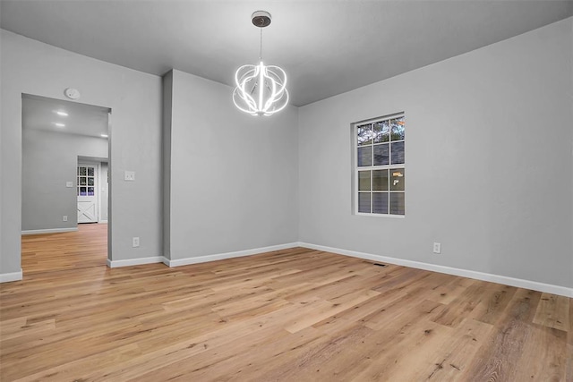 interior space featuring light hardwood / wood-style flooring and a chandelier