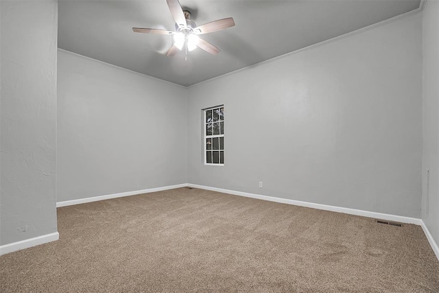 unfurnished room with ceiling fan, carpet floors, and ornamental molding