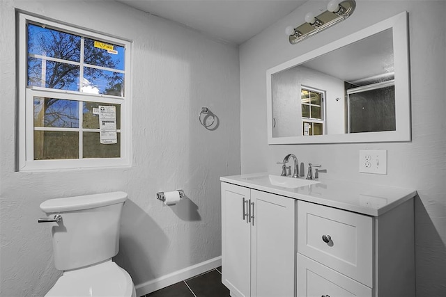 bathroom featuring tile patterned floors, vanity, and toilet