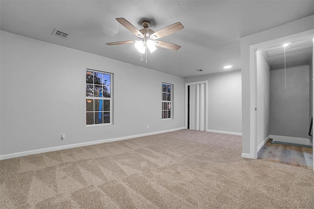 carpeted empty room featuring ceiling fan