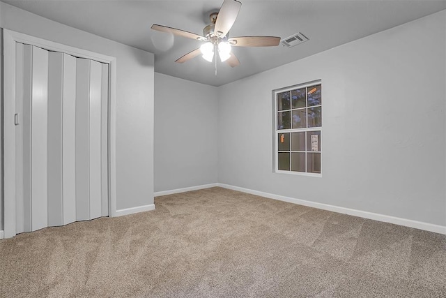 carpeted empty room with ceiling fan