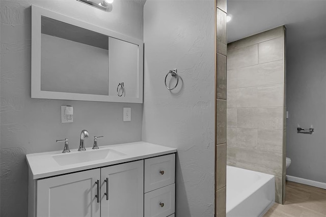 full bathroom featuring hardwood / wood-style floors, vanity, toilet, and tiled shower / bath combo