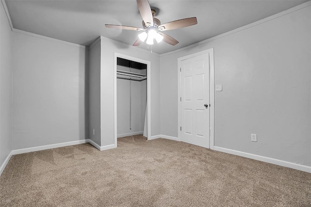 unfurnished bedroom featuring light carpet, a closet, ceiling fan, and crown molding