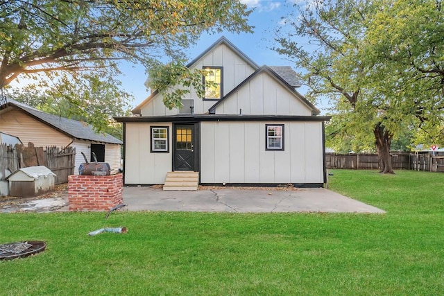 rear view of property featuring a lawn