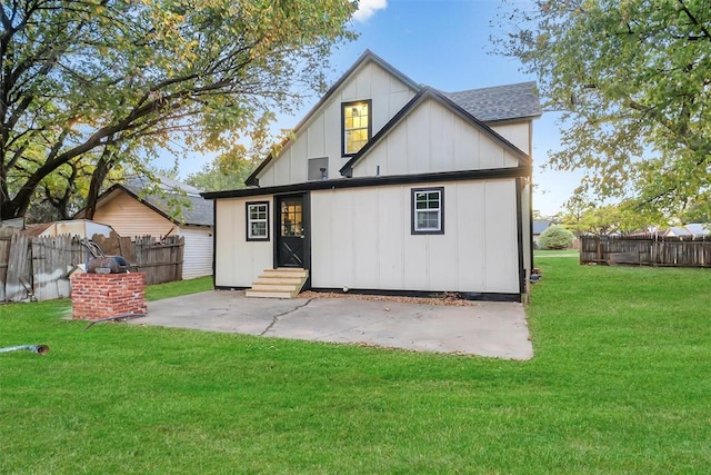 back of house featuring a patio area and a yard