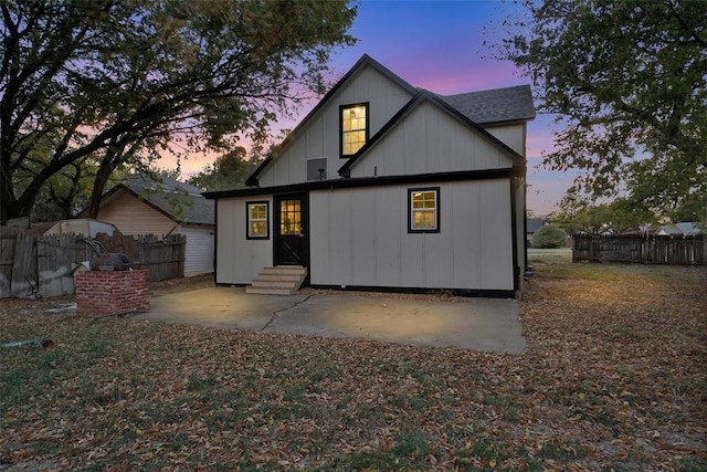 view of back house at dusk