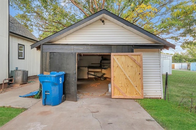 view of outbuilding featuring a lawn and central air condition unit