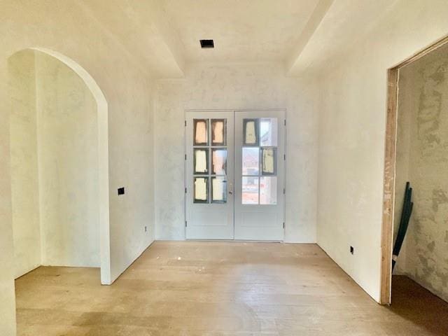 entryway with french doors and light hardwood / wood-style floors