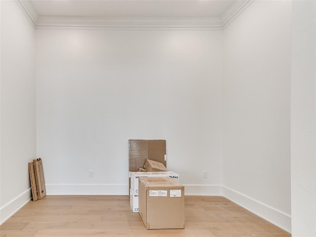 interior space featuring light wood-style floors, ornamental molding, and baseboards