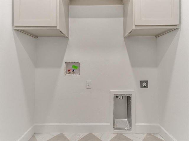 laundry area with hookup for a washing machine, cabinet space, hookup for an electric dryer, and baseboards