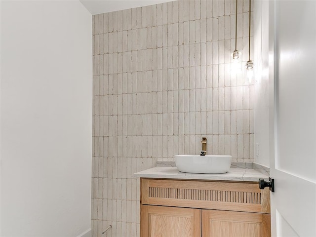 bathroom with tile walls and vanity