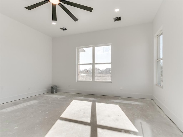 empty room featuring visible vents, baseboards, and unfinished concrete floors