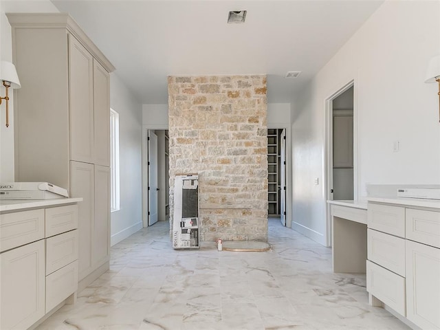 bathroom featuring marble finish floor, visible vents, and baseboards