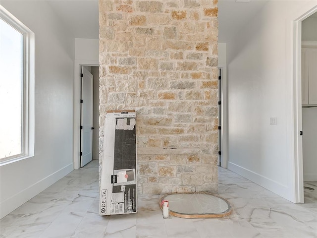 interior space featuring heating unit and baseboards