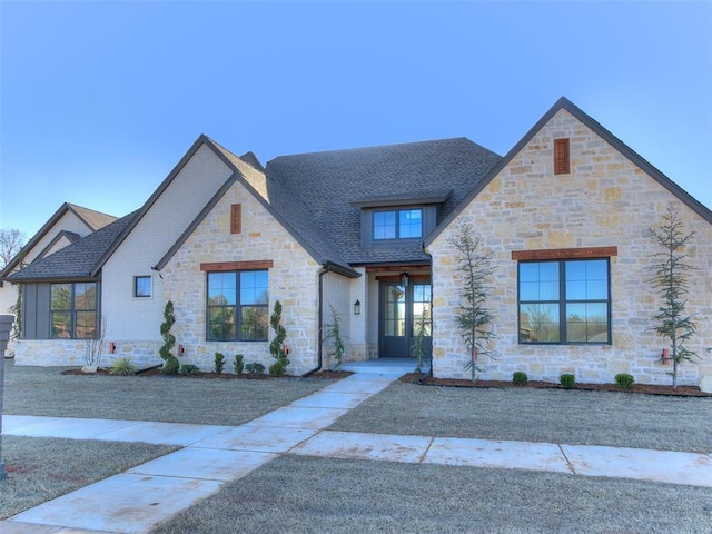 view of front of property featuring roof with shingles