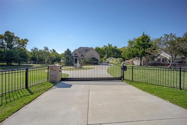 view of gate featuring a yard