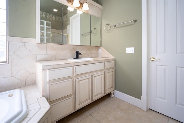 bathroom featuring a washtub, vanity, and tile patterned flooring