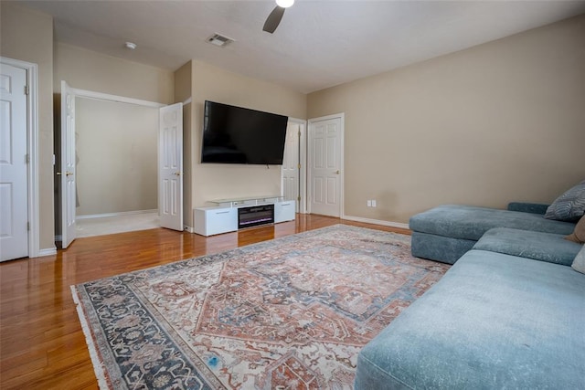 living room with ceiling fan and hardwood / wood-style flooring