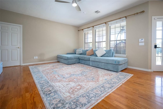 living room featuring ceiling fan and wood-type flooring