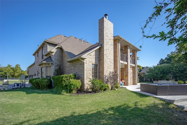 view of side of property with outdoor lounge area, a patio, a balcony, and a yard