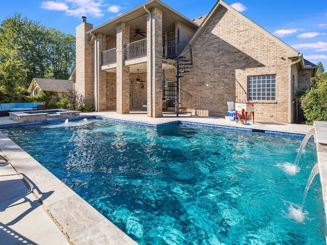 view of pool featuring pool water feature, a patio, an in ground hot tub, and ceiling fan