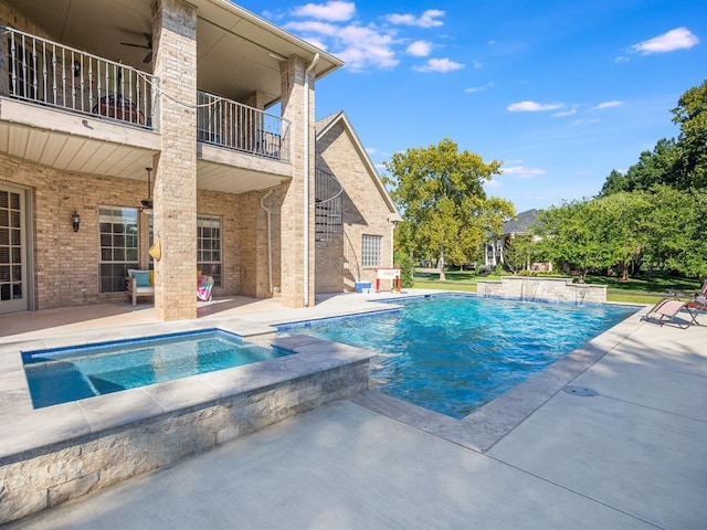 view of swimming pool featuring ceiling fan, a patio, and an in ground hot tub