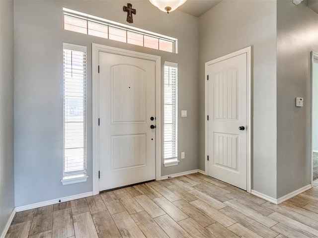 foyer entrance featuring plenty of natural light and light hardwood / wood-style floors