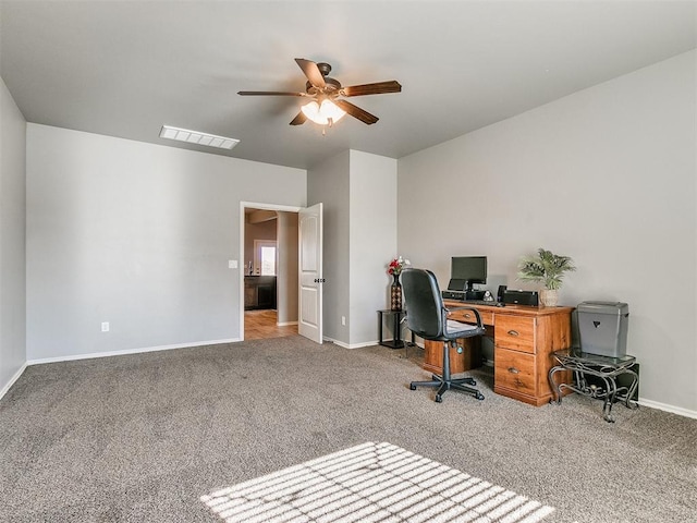 office with carpet flooring and ceiling fan