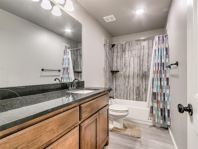 full bathroom featuring hardwood / wood-style floors, vanity, shower / bath combination with curtain, and toilet