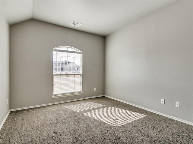 unfurnished room with lofted ceiling and carpet floors