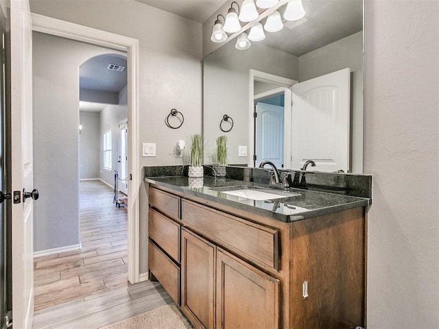 bathroom with hardwood / wood-style floors and vanity