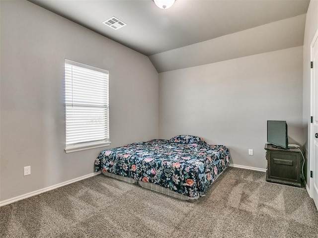 bedroom with carpet flooring and lofted ceiling