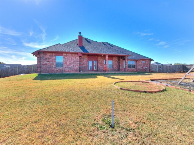 rear view of property with a lawn and french doors