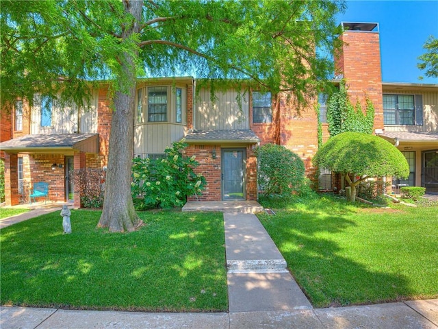 view of property featuring a front lawn