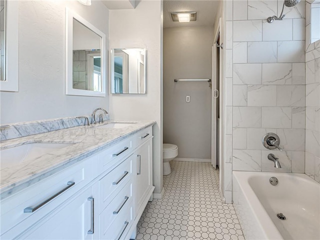 full bathroom with tile patterned floors, vanity, toilet, and tiled shower / bath