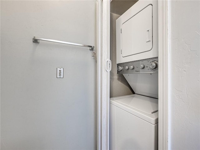 laundry area with stacked washer / drying machine