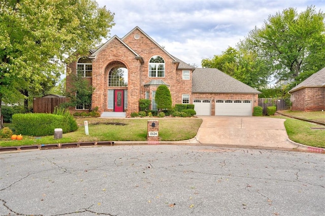 view of property featuring a front yard and a garage