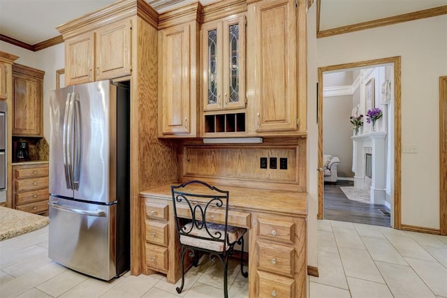 kitchen featuring stainless steel fridge, crown molding, light brown cabinets, and light hardwood / wood-style flooring