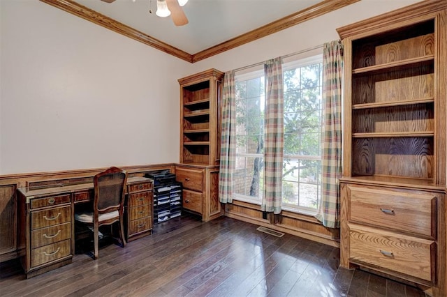 home office with crown molding, ceiling fan, and dark wood-type flooring