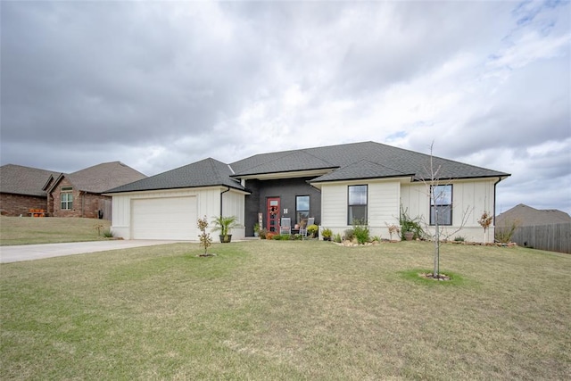 view of front of house featuring a garage and a front lawn