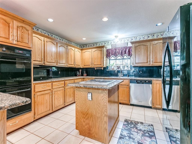 kitchen with decorative backsplash, sink, black appliances, light tile patterned floors, and a center island