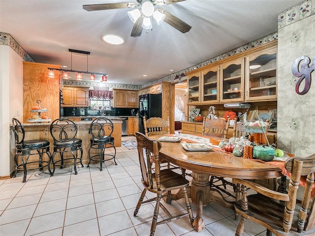 tiled dining space featuring ceiling fan