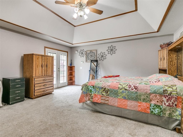 carpeted bedroom featuring ceiling fan, access to outside, a tray ceiling, and french doors