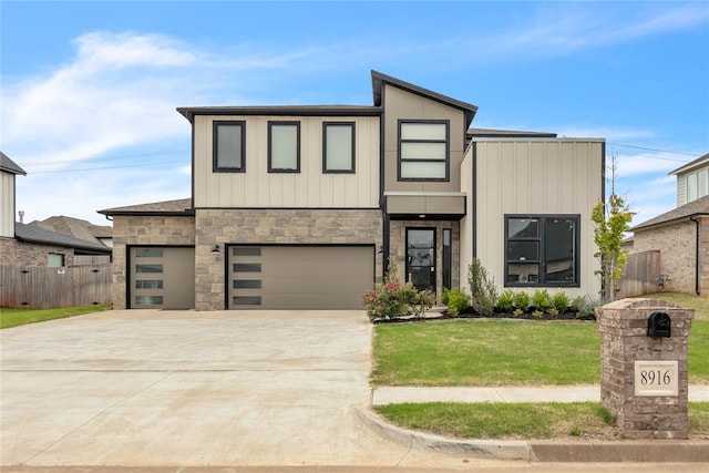 view of front of property featuring a garage and a front lawn