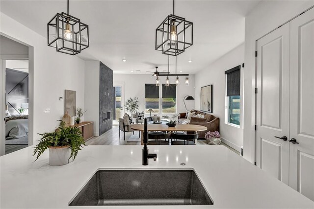 kitchen featuring sink, decorative light fixtures, and hardwood / wood-style flooring