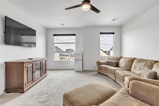 carpeted living room featuring ceiling fan