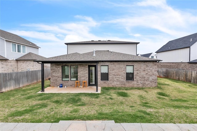 back of property with a patio area and a yard